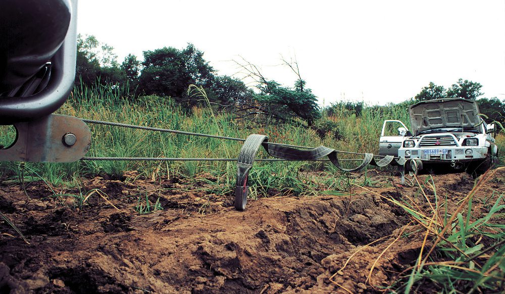 Emergency Winch Out Service Ecorse MI recovering a stranded SUV with a heavy-duty tow truck and professional winching equipment.