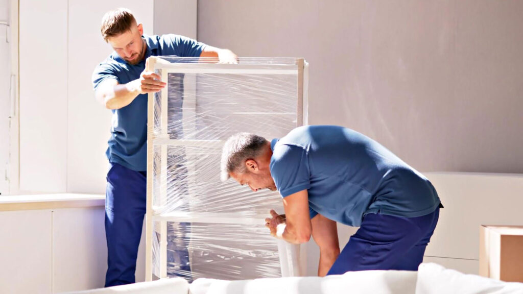 Professional Local Relocation Bradenton, FL movers carrying furniture from a home