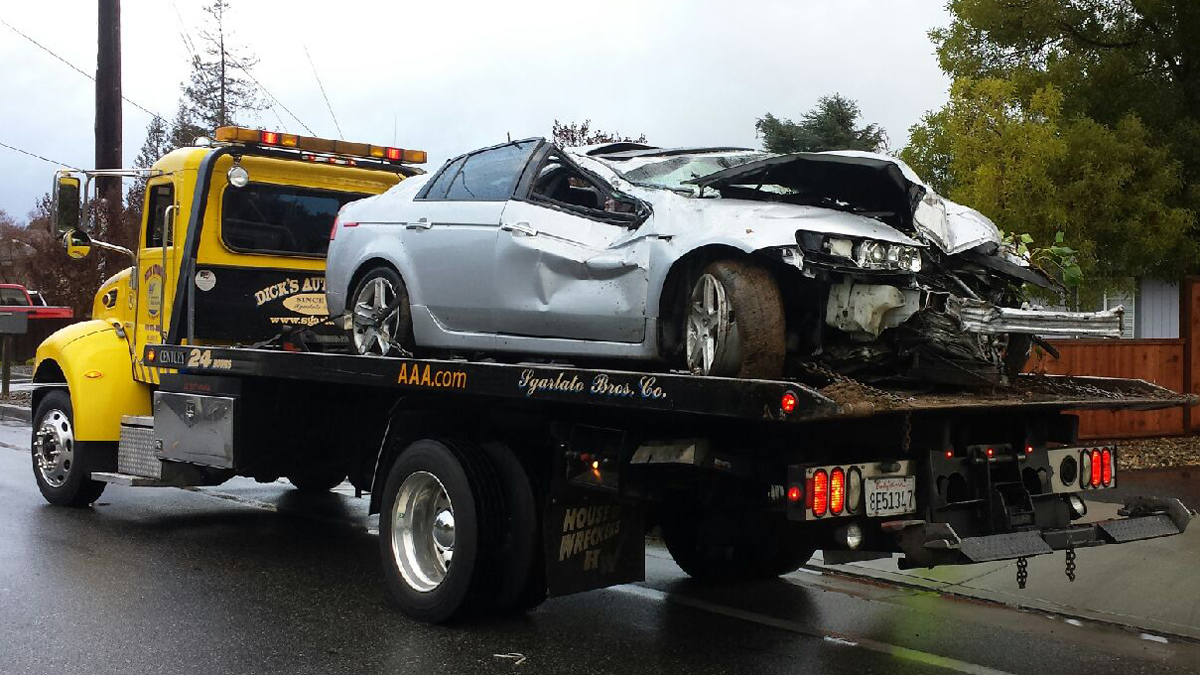 Tow truck driver assisting customer after car accident Detroit